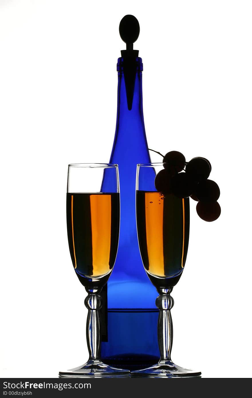 Dark blue bottle of wine, glasses with wine and grapes. Dark blue bottle of wine, glasses with wine and grapes