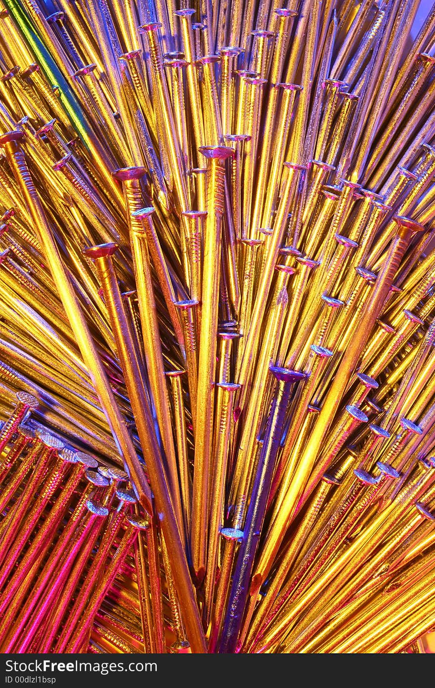 Arrangement of nails of different sizes in coloured light, some of them painted. Arrangement of nails of different sizes in coloured light, some of them painted