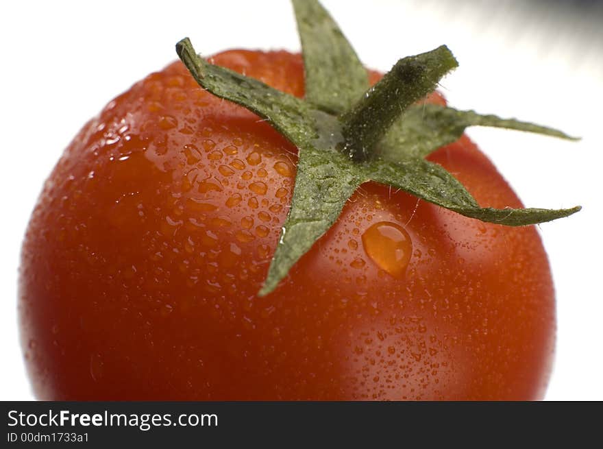 Red cherry tomatowith water drops close up shoot