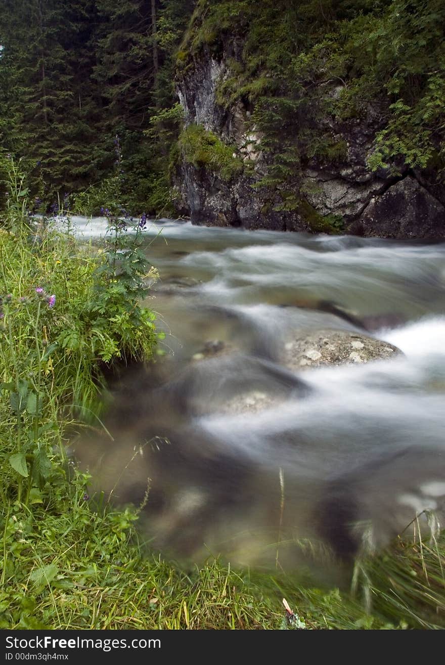 A stream or creek, is a body of water with a detectable current, confined within a bed and banks. A stream or creek, is a body of water with a detectable current, confined within a bed and banks.