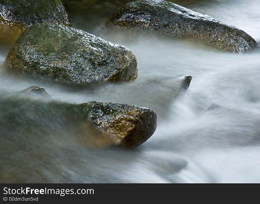 A stream or creek, is a body of water with a detectable current, confined within a bed and banks. A stream or creek, is a body of water with a detectable current, confined within a bed and banks.