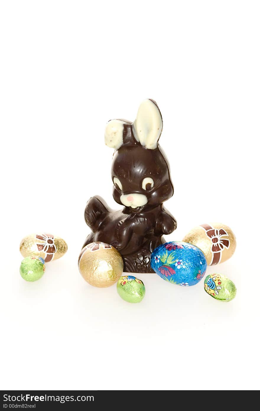 A chocolate easter bunny and easter eggs isolated on white