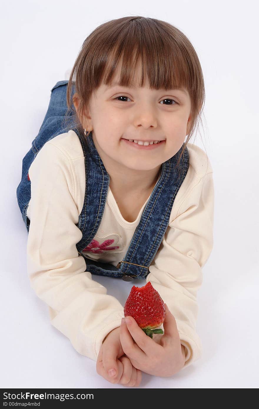 Isolated portrait of little girl who eates strawberry. Isolated portrait of little girl who eates strawberry