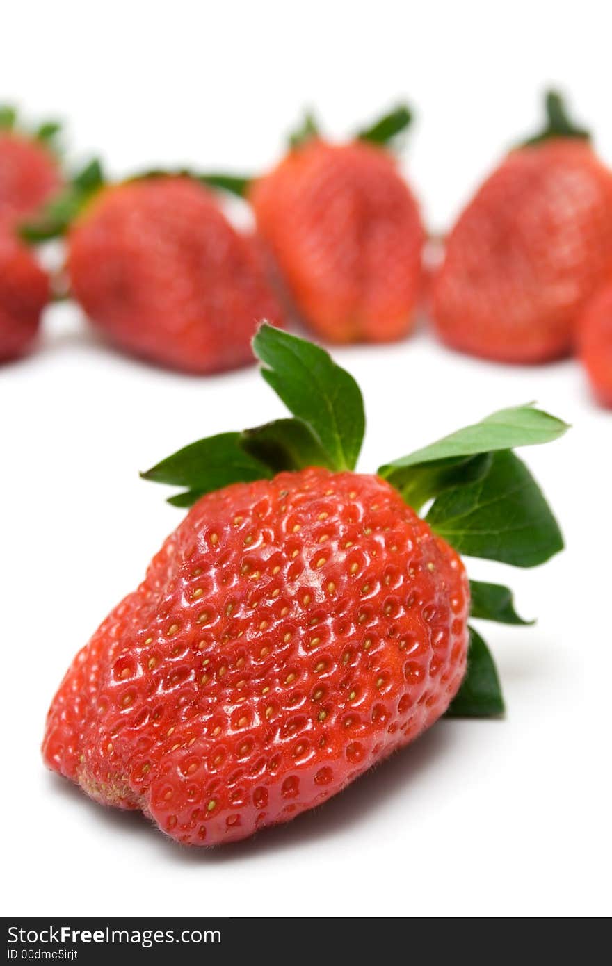 Bunch of Strawberries. Front one focused. Isolated on a white background. Bunch of Strawberries. Front one focused. Isolated on a white background.