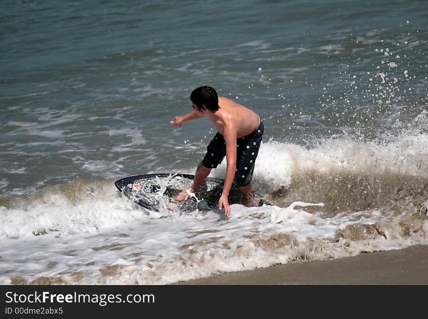 Young man boogie boarding in the Pacific