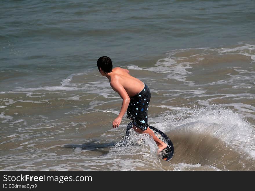 Young man boogie boarding in the Pacific