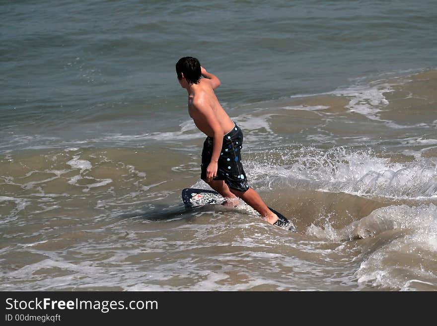 Young man boogie boarding in the Pacific