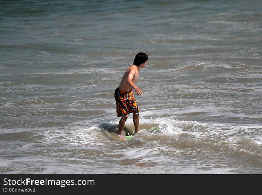 Young man boogie boarding in the Pacific