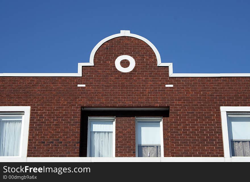 Facade and ornamental rooftop of a red brick house. Facade and ornamental rooftop of a red brick house.