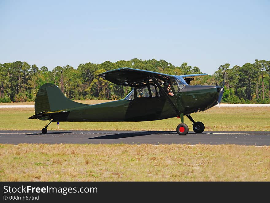 Light private airplane in dark green color. Light private airplane in dark green color