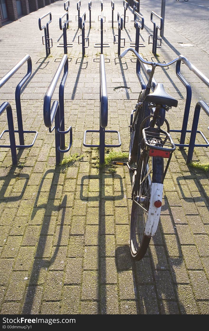 One old dutch bicycle in a modern steel stand. One old dutch bicycle in a modern steel stand.