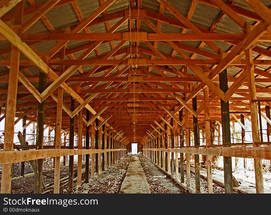 Image of inside of long wooden building giving the effect of tunnel vision