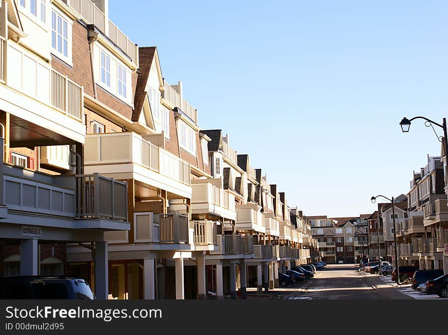 Photo of condominium building with blue sky. Photo of condominium building with blue sky