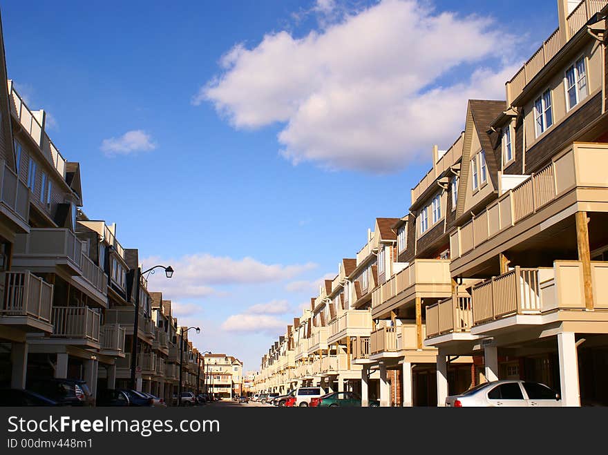 Photo of condominium building with blue sky. Photo of condominium building with blue sky