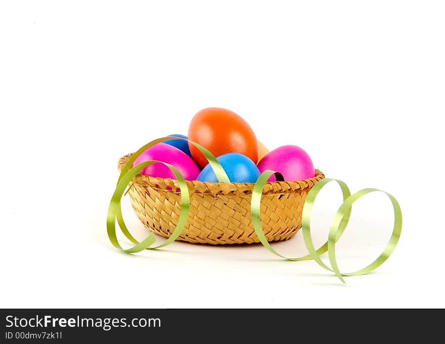 Color easter eggs in a small basket