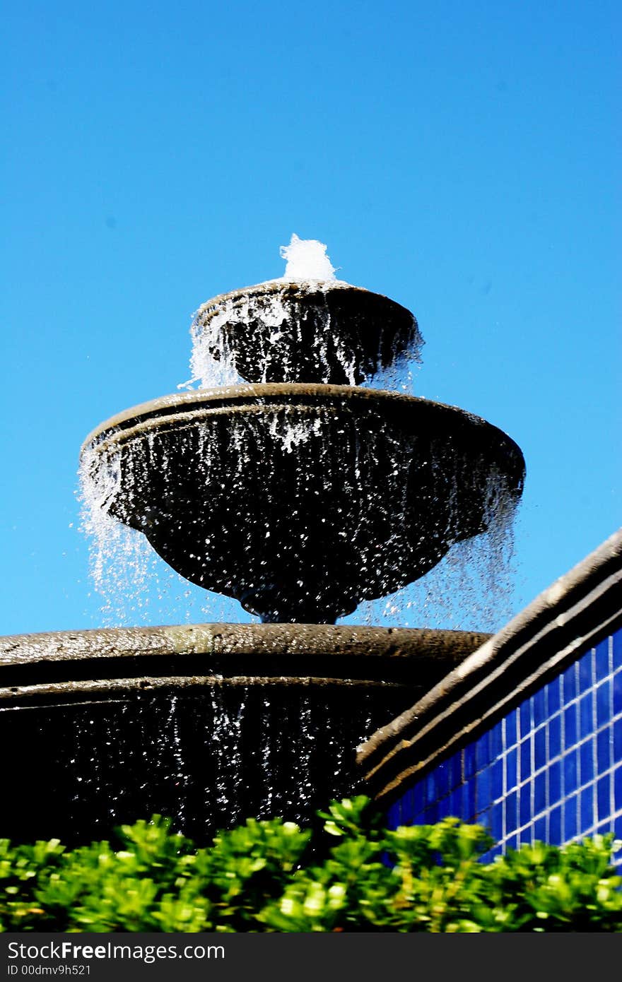 This fountain was taken in Cabo San Lucas.  The backdrop of the mid-day sky sets off the water and the base with plants