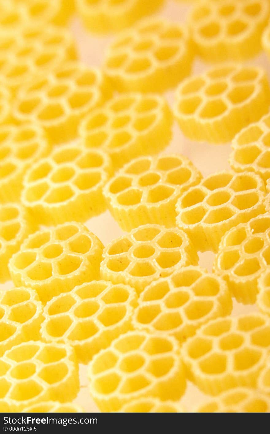 Figured macaroni products are scattered on  surface of  table