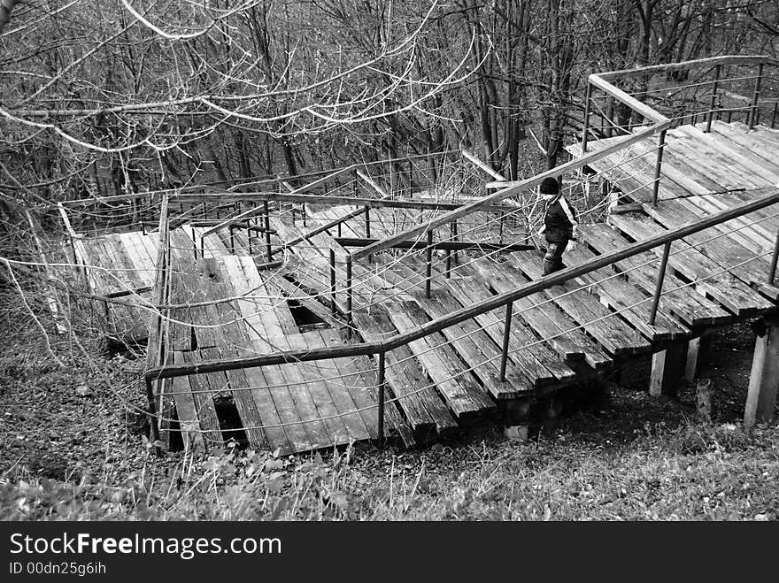 The wooden stairs with boy in spring park