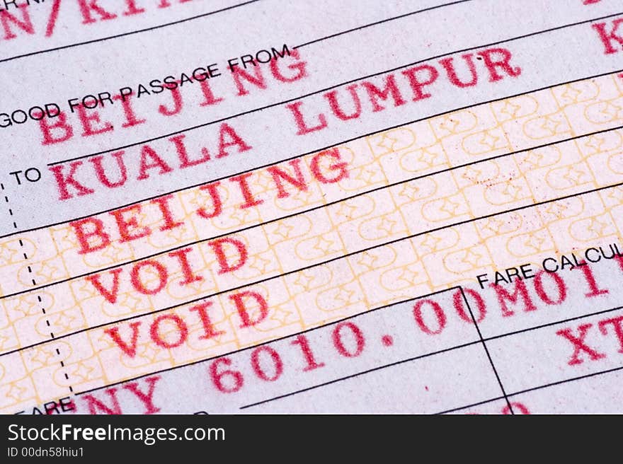 Extreme close up on airline ticket from Beijing to Kuala Lumpur.