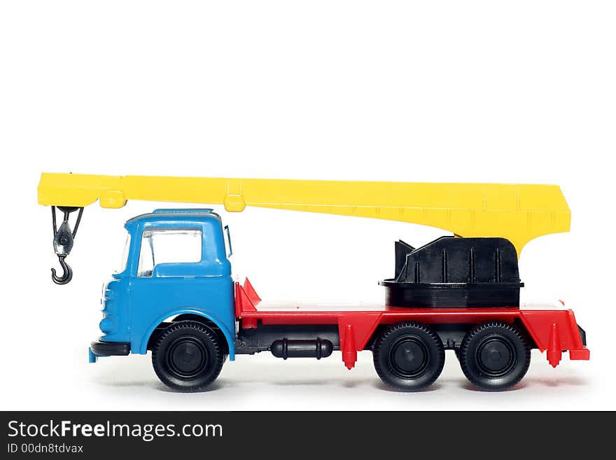 Picture of a old small Bedford crane truck. Greek plastic toy from my brothers toy collection. Isolated on real white. Picture of a old small Bedford crane truck. Greek plastic toy from my brothers toy collection. Isolated on real white