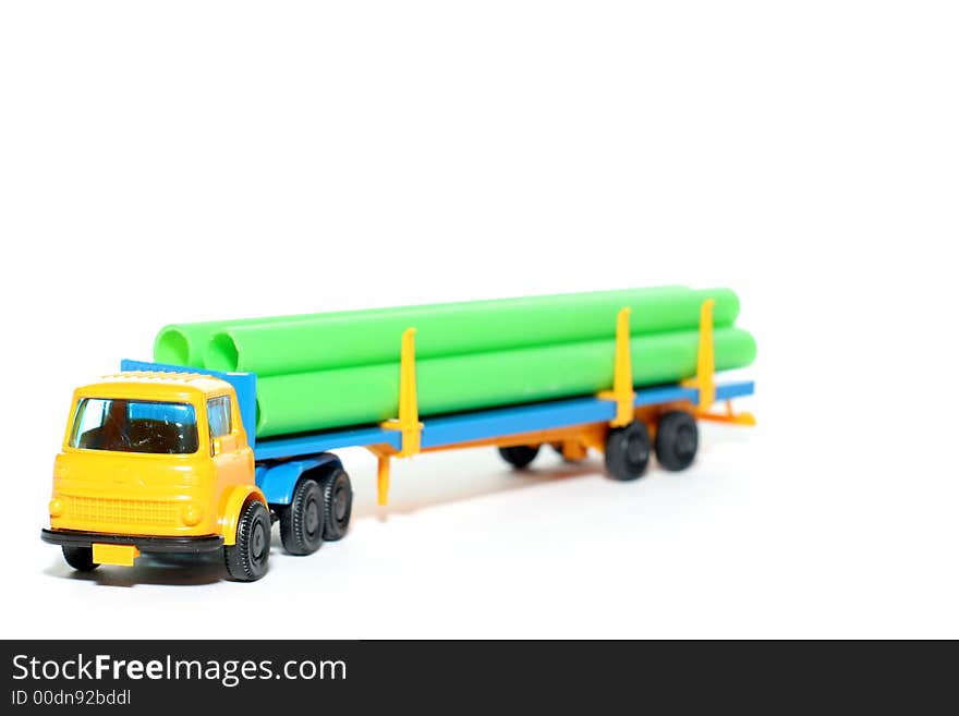 Picture of a old small Bedford Pipe Transporter truck. Greek plastic toy from my brothers toy collection. Isolated on real white. Picture of a old small Bedford Pipe Transporter truck. Greek plastic toy from my brothers toy collection. Isolated on real white