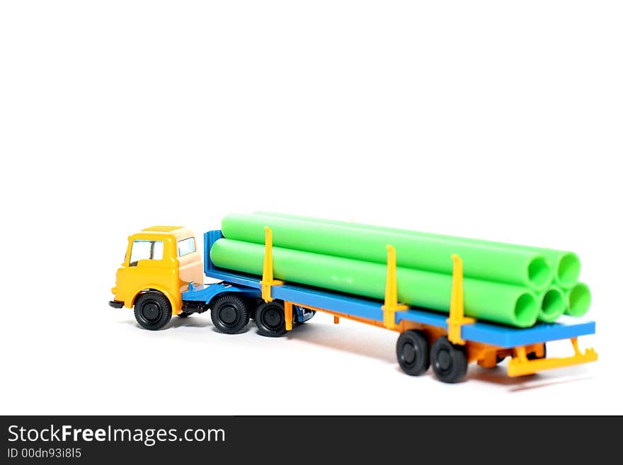 Picture of a old small Bedford Pipe Transporter truck. Greek plastic toy from my brothers toy collection. Isolated on real white. Picture of a old small Bedford Pipe Transporter truck. Greek plastic toy from my brothers toy collection. Isolated on real white