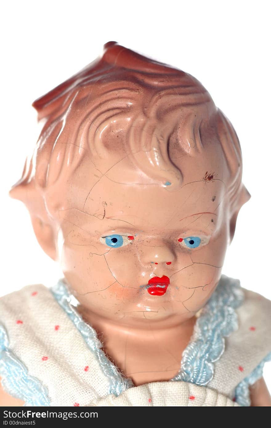 Picture of a old abused porcelain girl (or is it a boy???)doll. Dates around 1950 or later .Isolated on real white. Picture of a old abused porcelain girl (or is it a boy???)doll. Dates around 1950 or later .Isolated on real white