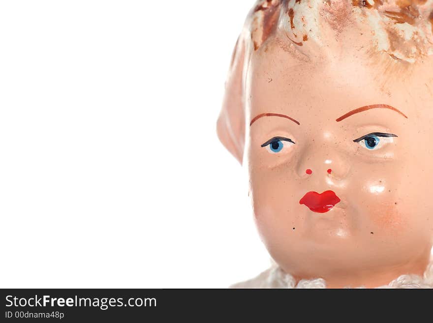 Picture of a old abused porcelain girl doll face. Dates around 1950 or later .Isolated on real white. Picture of a old abused porcelain girl doll face. Dates around 1950 or later .Isolated on real white