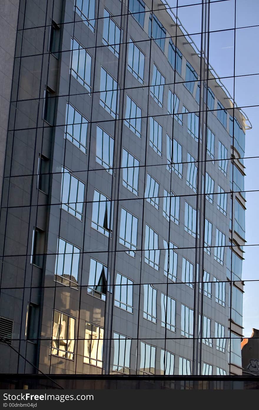 Building in sunrise reflected in another building. Building in sunrise reflected in another building