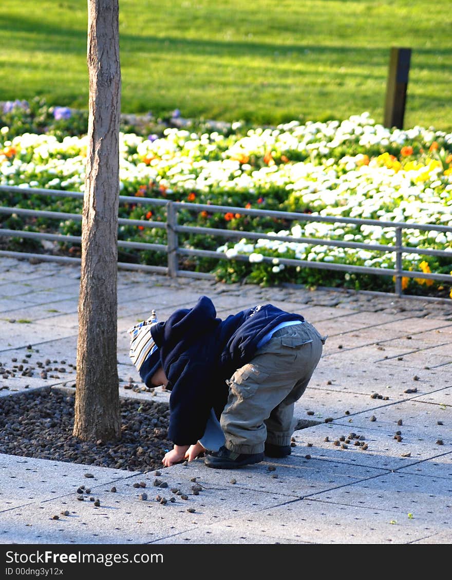 Little sweet kiddy is playing with some stones. Perhaps, in a hour all of them are outside;-). Little sweet kiddy is playing with some stones. Perhaps, in a hour all of them are outside;-)