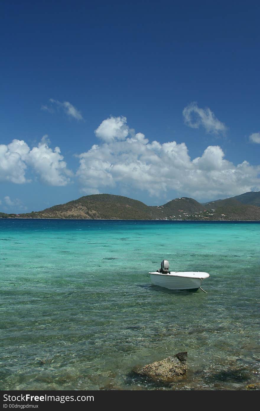This lonesome boat bobs gently on the quiet waves at Leinster Bay in St. John, USVI.