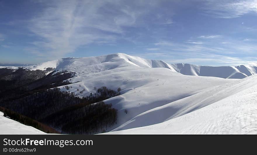 Panoramic picture of mountains covered with snow. Panoramic picture of mountains covered with snow