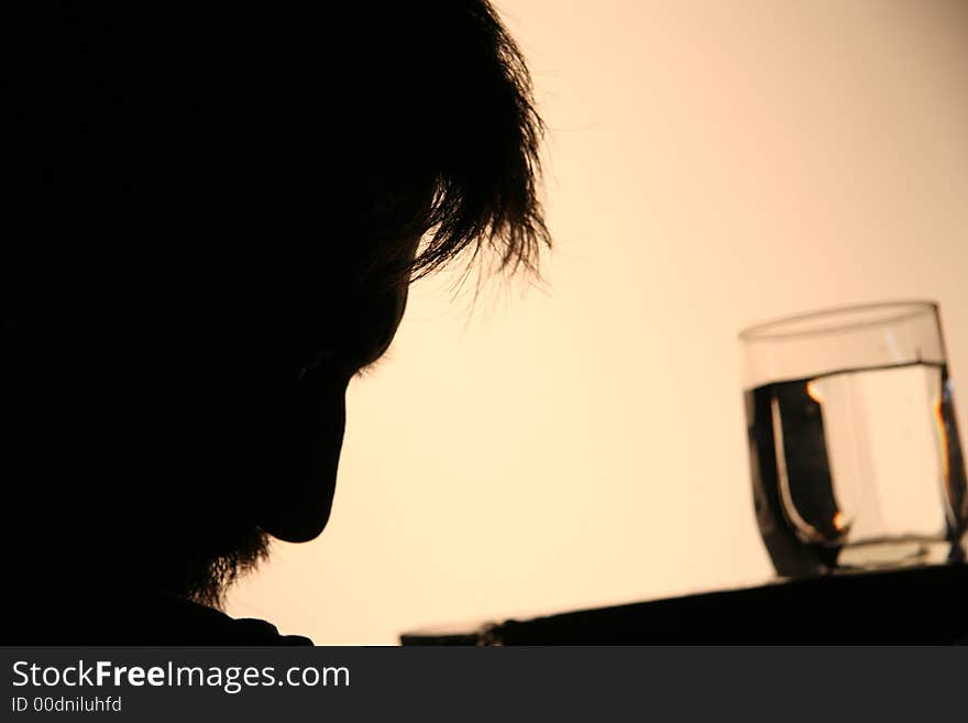 Profile of a men near the  table. Profile of a men near the  table.