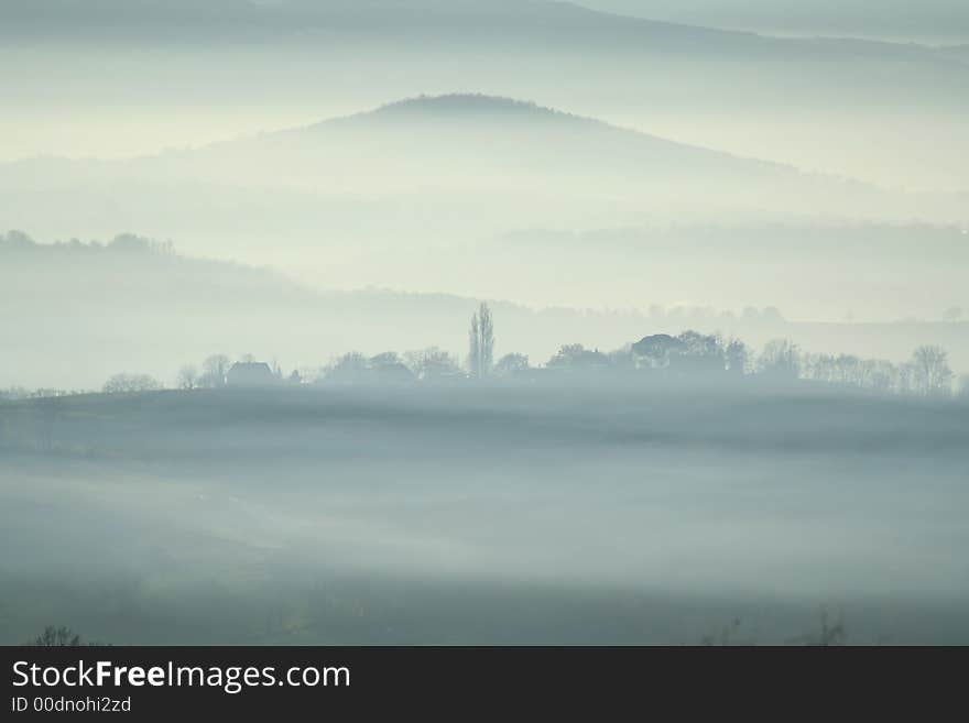 Misty village with mountain in backgroud