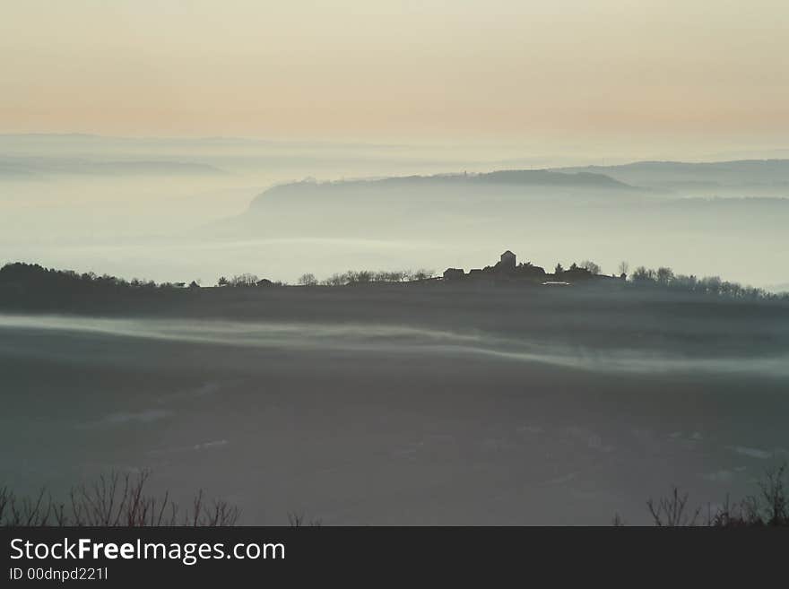 Misty village at sunset france