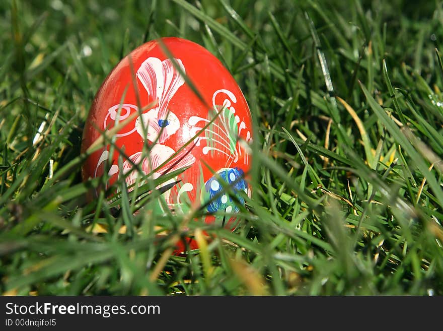 Red painted  easter egg with green background for europe