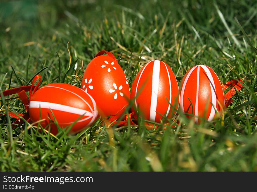 Four red painted easter egg with green background. Four red painted easter egg with green background