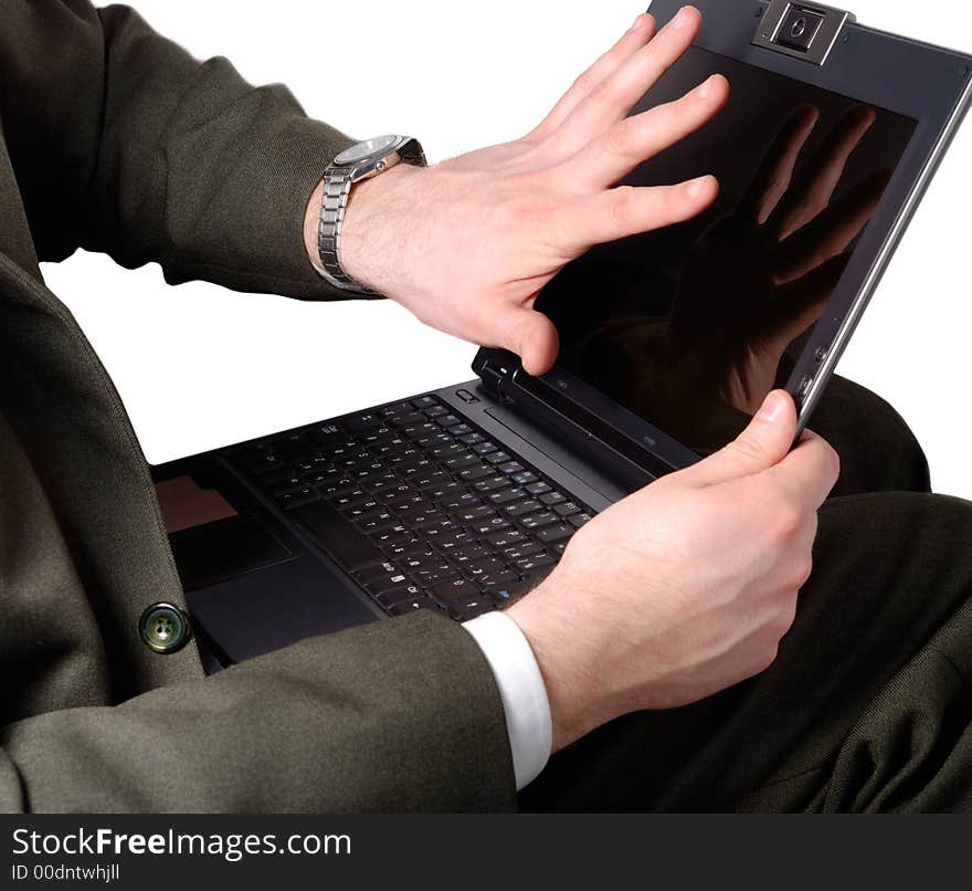 Businessman gesturing negative emotion to his laptop. Businessman gesturing negative emotion to his laptop