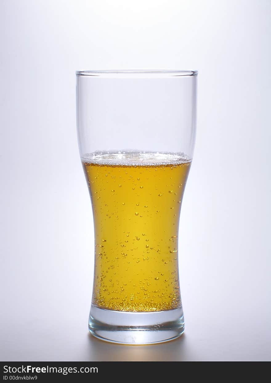 Beer within mug over a light blue  background. Beer within mug over a light blue  background