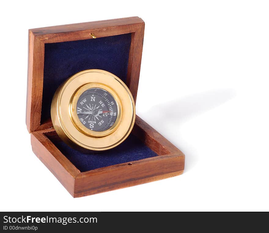 Small brass compass in box isolated over white background. Small brass compass in box isolated over white background