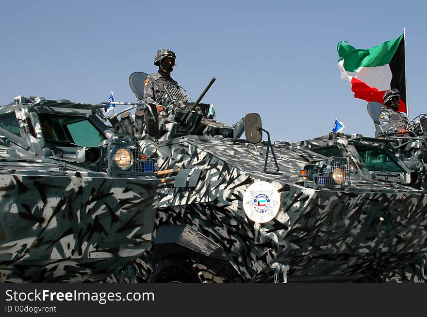 Kuwait flag flying in MOI over military vehicles and personnel. Kuwait flag flying in MOI over military vehicles and personnel.