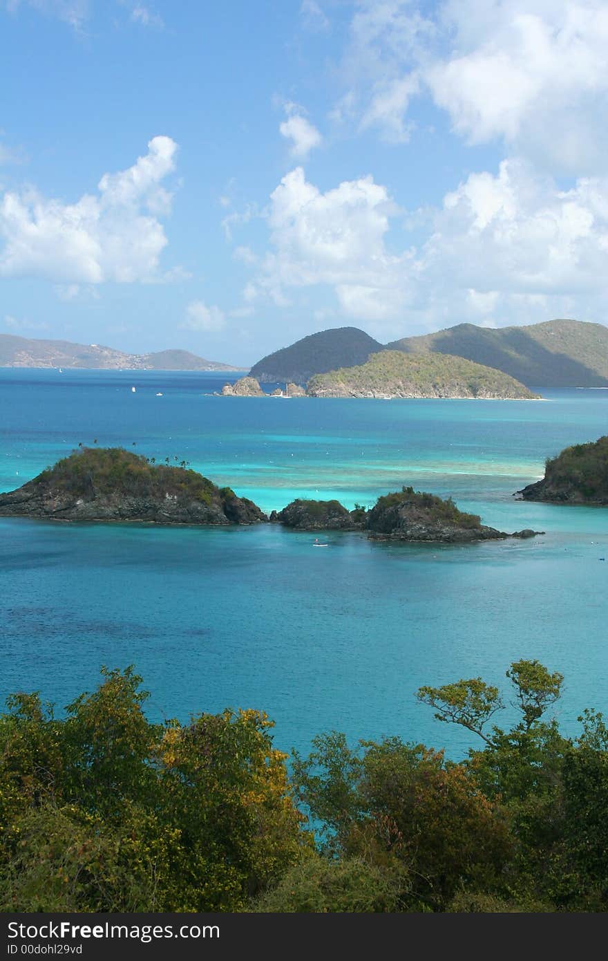 The sun dapples the water of Trunk Bay in light, creating a blue-green cast over the water. The sun dapples the water of Trunk Bay in light, creating a blue-green cast over the water.