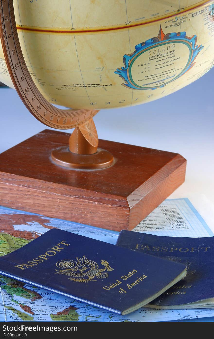 A globe, map & passport with a sky blue backdrop.
 Planning stages of a trip. On the move again. A globe, map & passport with a sky blue backdrop.
 Planning stages of a trip. On the move again.