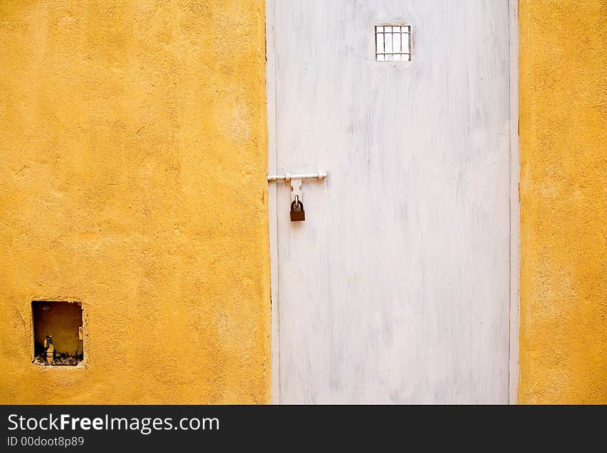 Locked white door with yellow background. Locked white door with yellow background