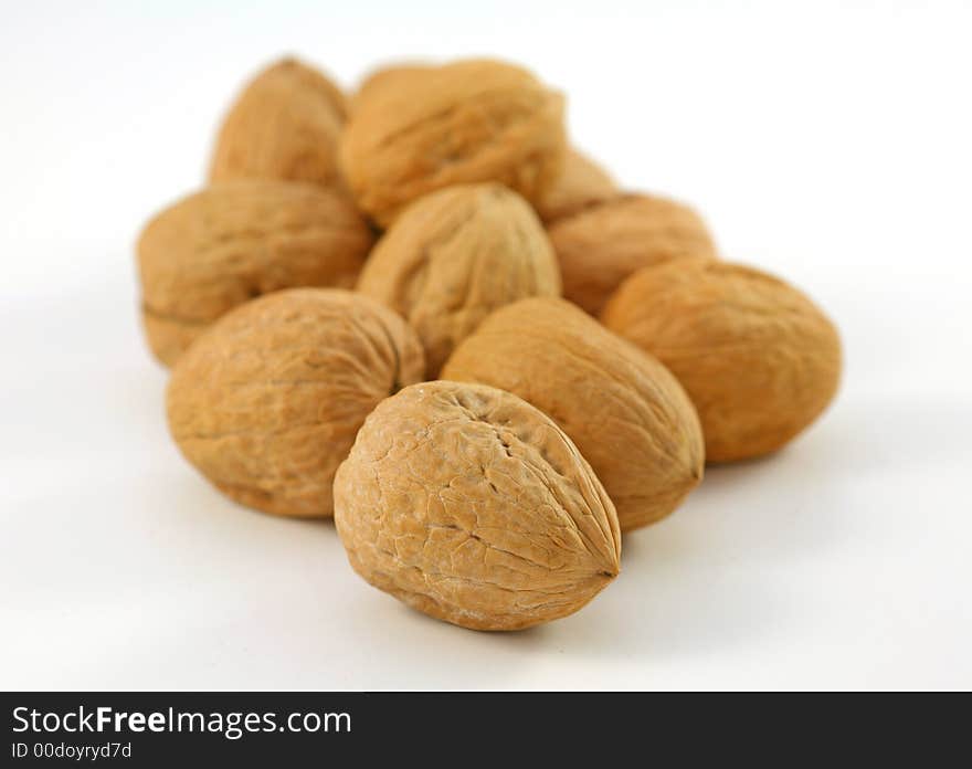 Whole walnuts in shell over the white background