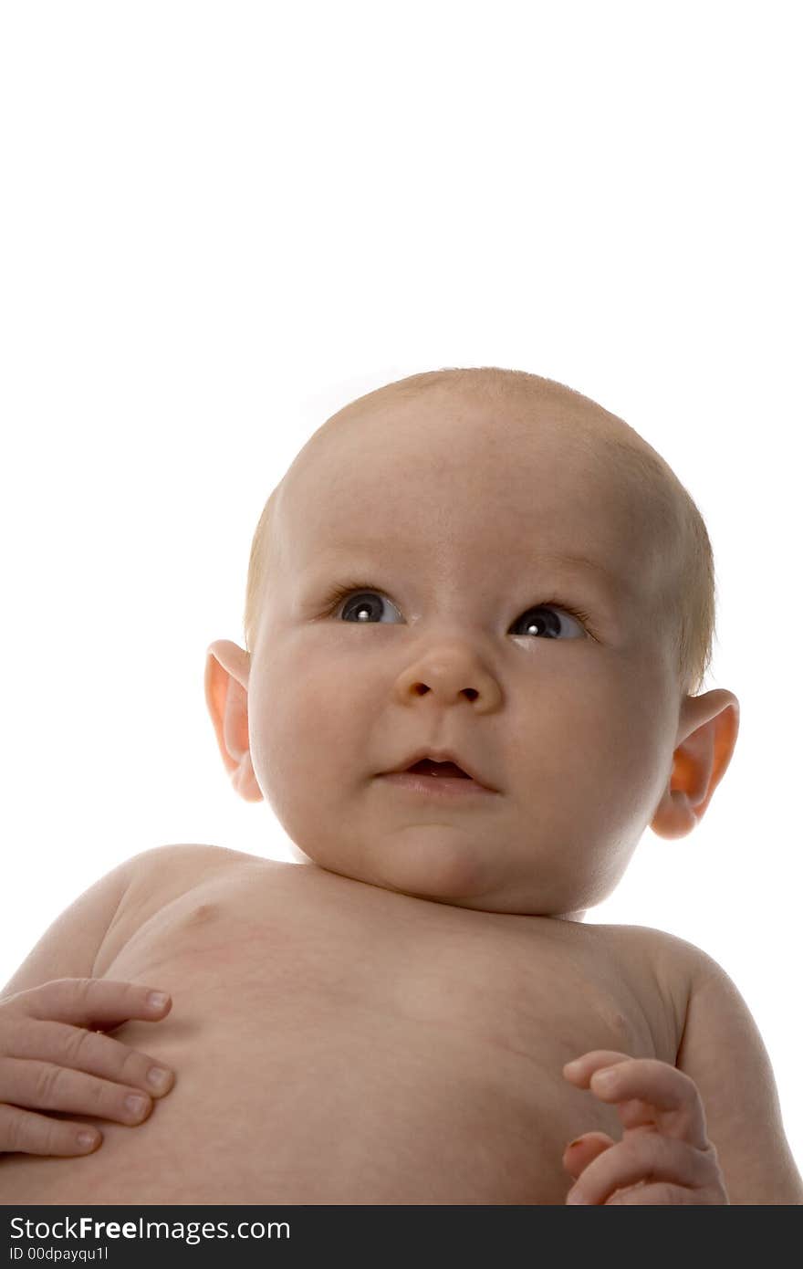 Infant baby looking up with half smile, on white background. Infant baby looking up with half smile, on white background