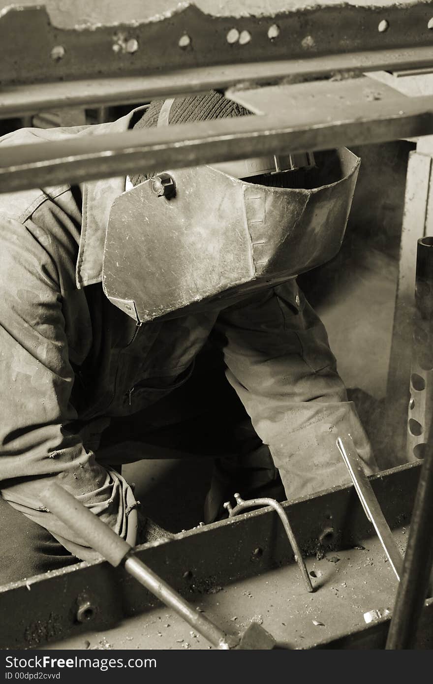 Welder working an industrial background. Welder working an industrial background