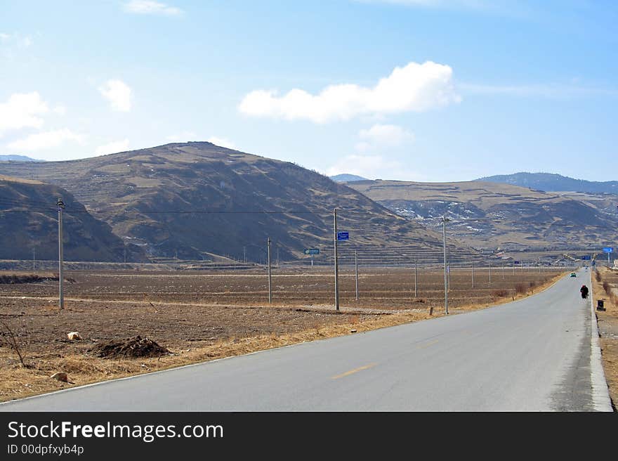 Landscape with highway,mountains and sky