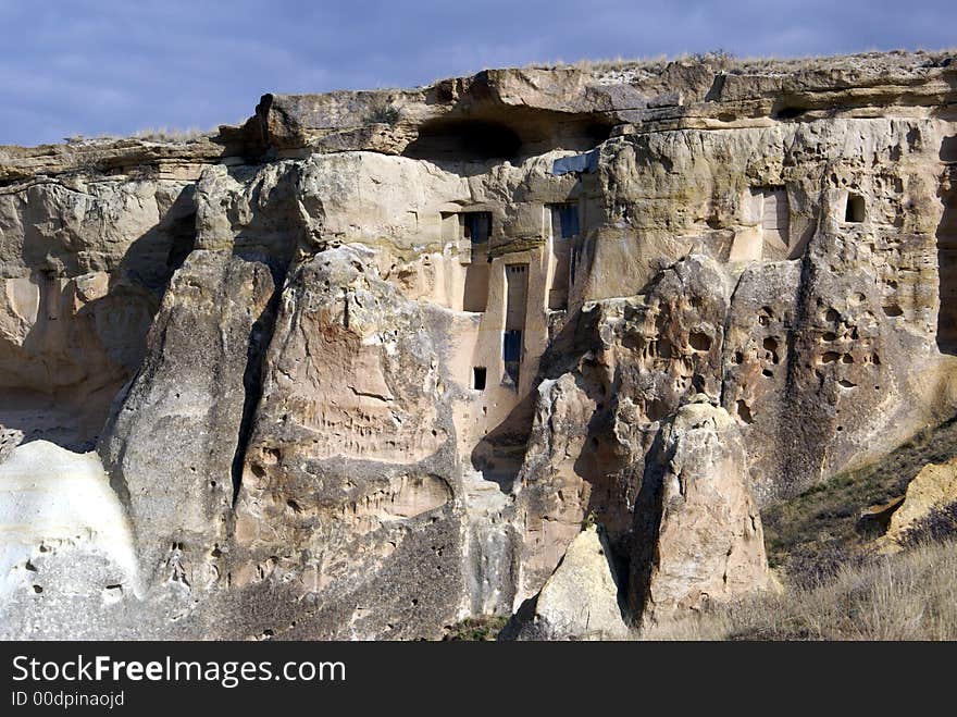 Rock with windows in mountain area near Chavushin, Cappadocia, Turkey