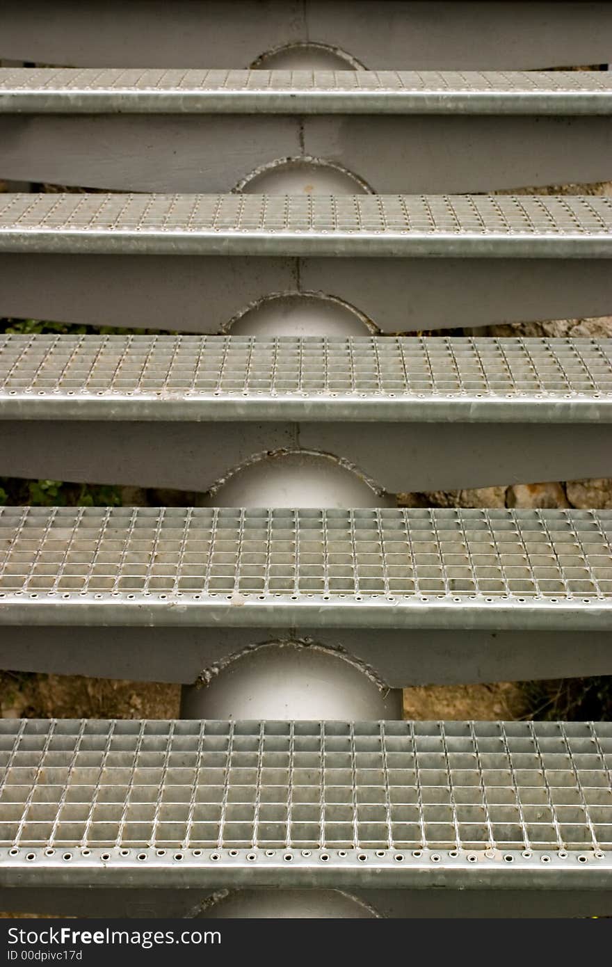 Stainless steel grated stairs leading upwards.  Athens, Greece. Stainless steel grated stairs leading upwards.  Athens, Greece.